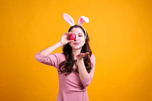 istock Joyful female posing for easter themed photoshoot with bunny ears. 1207708307