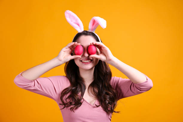 istock Joyful female posing for easter themed photoshoot with bunny ears. 1207708389