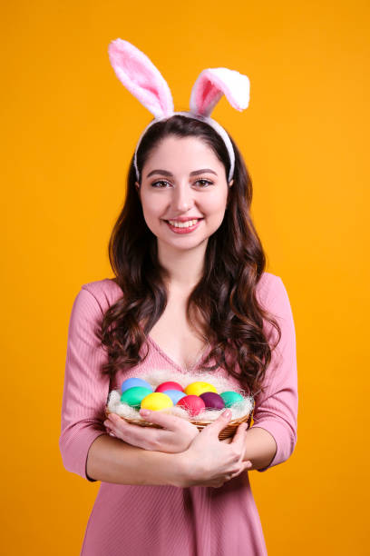 istock Joyful female posing for easter themed photoshoot with bunny ears. 1207708486