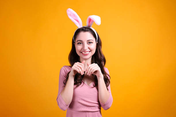 istock Joyful female posing for easter themed photoshoot with bunny ears. 1207708495