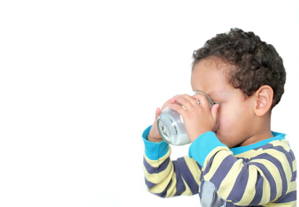 istock child drinking milk stock photo 1207708658