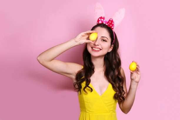 istock Joyful female posing for easter themed photoshoot with bunny ears. 1207708773