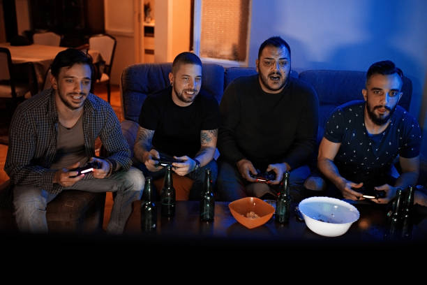 istock Four guys playing video games 1207708780