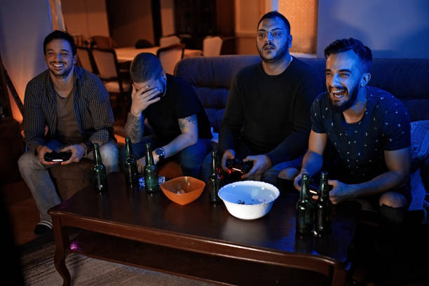 istock Male friends playing video game 1207708820