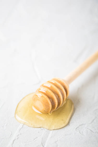 istock Natural flower honey in a glass jar 1207711045