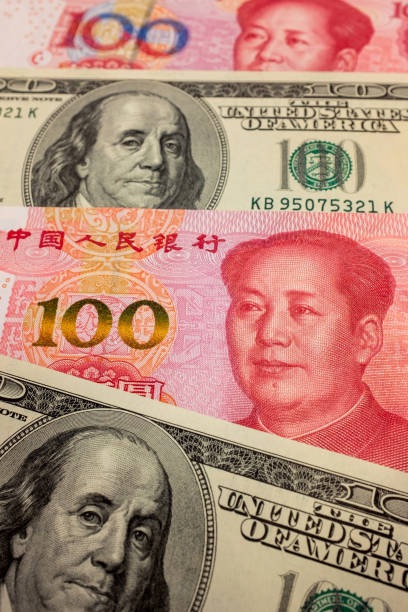 istock Chinese Yuan Note and U.S. dollar background 1207712411