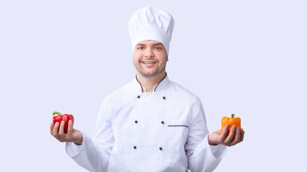 istock Chef Guy Holding Sweet Peppers Standing On White Studio Background 1207712857