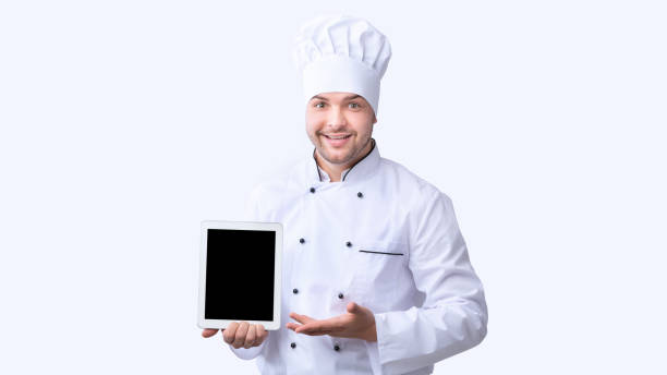 istock Chef Showing Blank Tablet Screen Standing Over White Background, Panorama 1207714594