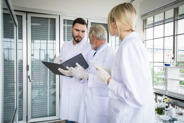istock Medical Research and Scientists are working with a microscope and a tablet and Test Tubes, Micropipette and Analysis Results in a laboratory. 1207715617