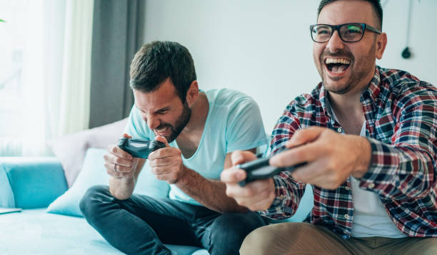 istock Excited friends playing video games 1207715730