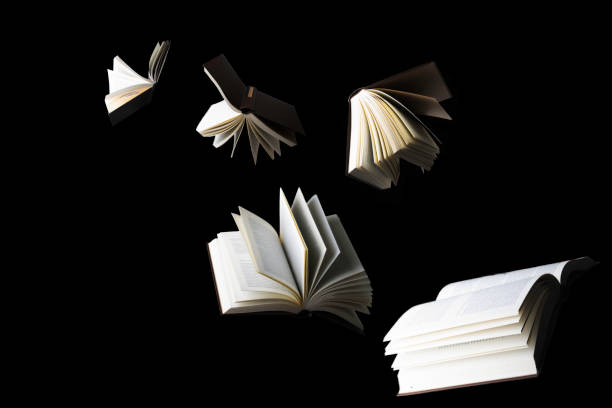 Flying books isolated on black background stock photo