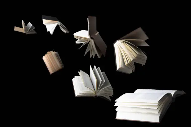 Photo of Flying books isolated on black background
