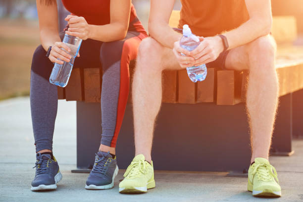 istock Modern couple making pause in an urban park during jogging / exercise. 1207719407