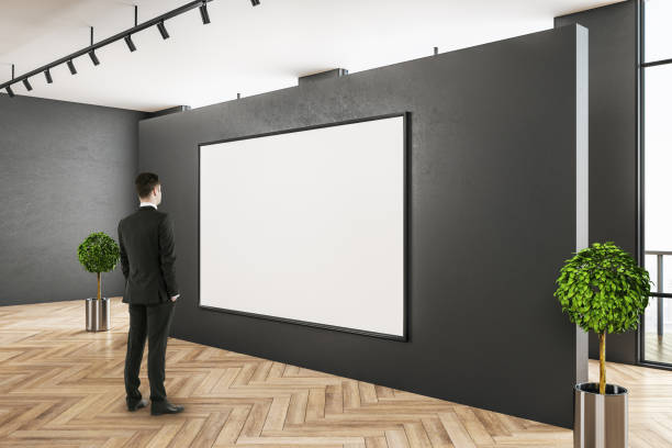 istock Businessman in modern gallery interior 1207719481