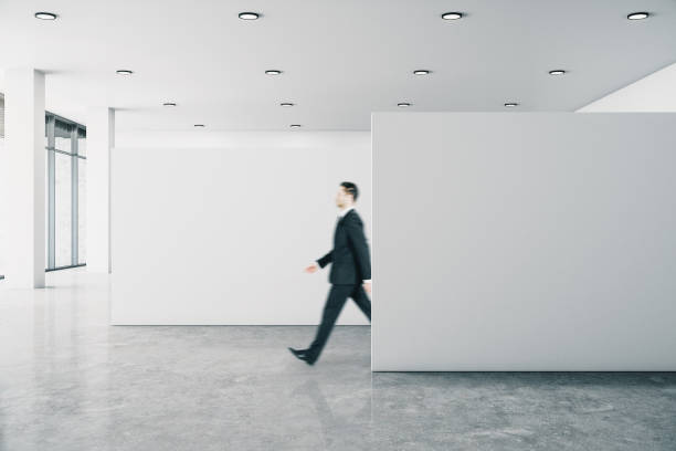 istock Businessman in gallery with banner 1207719586
