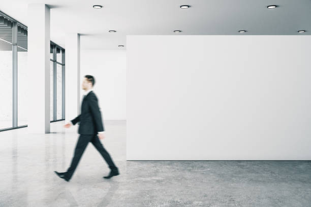 istock Businessperson in gallery with poster 1207719607