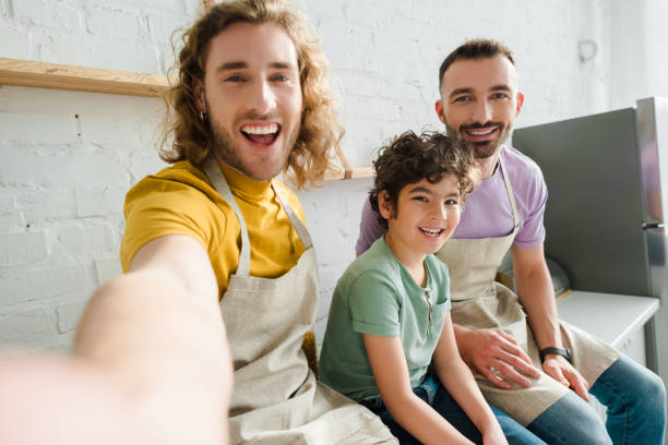 istock selective focus of handsome homosexual men smiling with cute mixed race kid 1207719952