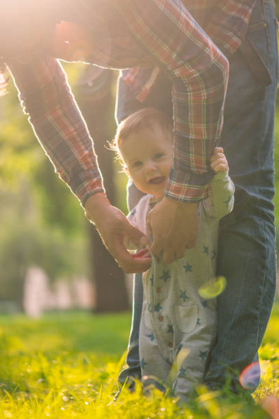 istock Baby boy with is father enjoying summer day 1207720094