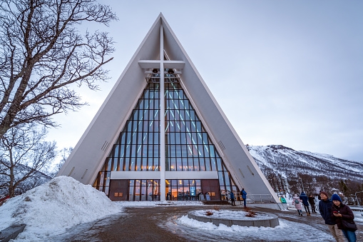 Tromso, Norway - February 8, 2020: The facade of the minimalistic white Arctic Church on a cloudy day. The church is one of the most notable churches in Tromso due to its design
