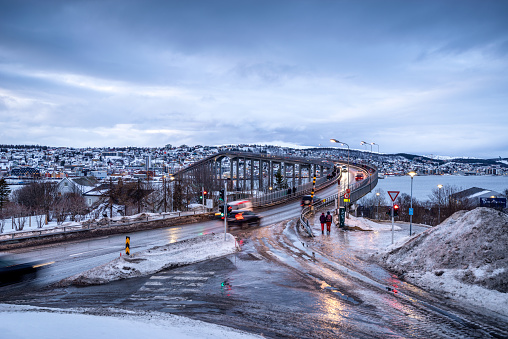 Tromso, Norway - february 08, 2020: Tromso Bridge across Tromsoysundet strait at dusk