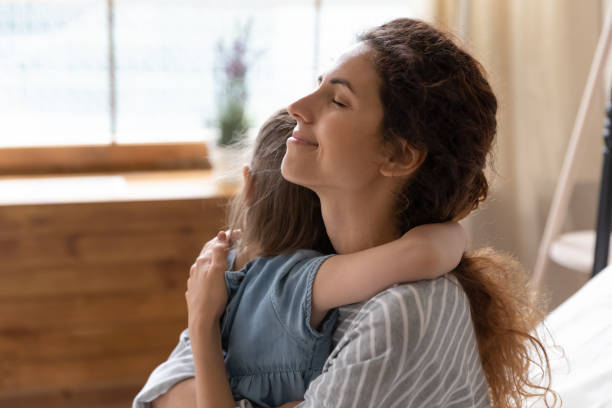 istock Affectionate loving mom cuddling little preschool daughter. 1207723253