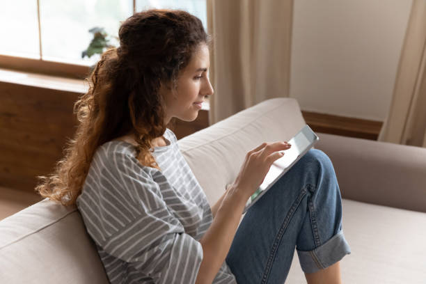 istock Addicted to technology millennial lady chatting in social networks. 1207723283
