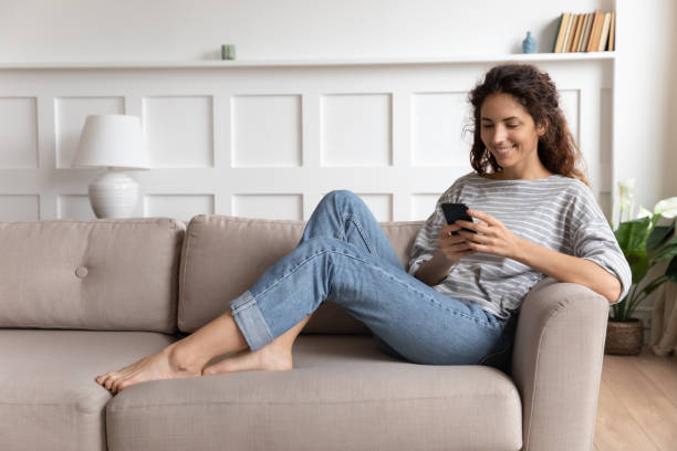 istock Smiling pretty young woman using funny mobile apps. 1207723289