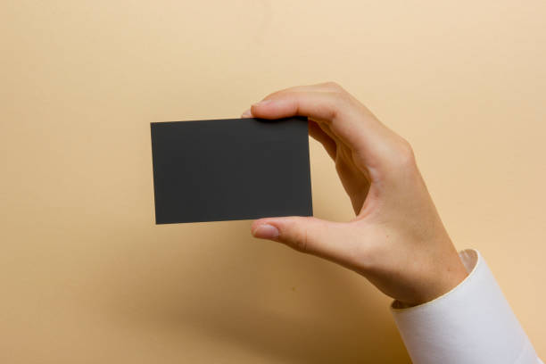 istock Hand holding white business card on white background 1207725180