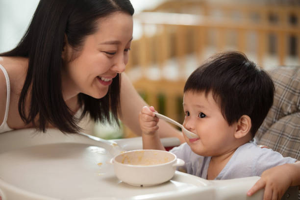 istock Mother to feed the baby 1207726360