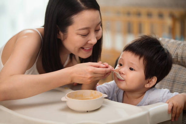 istock Mother to feed the baby 1207726454