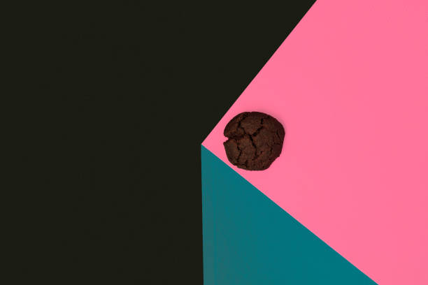 istock Chocolate biscuit above a pink background. Copy space 1207726550