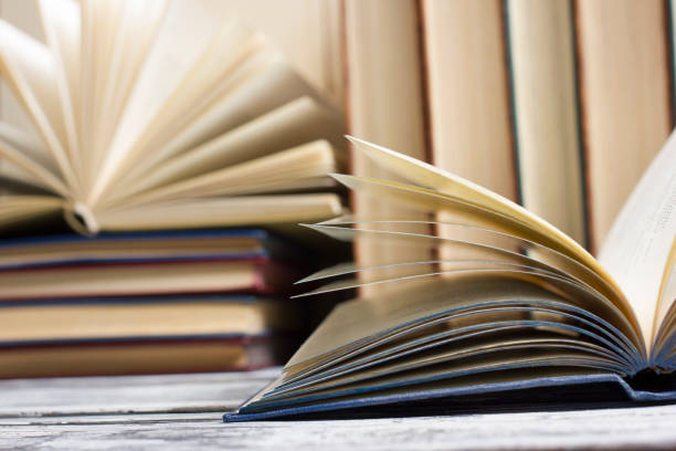 istock Open book, hardback books on wooden table. Back to school. Copy space. 1207726685