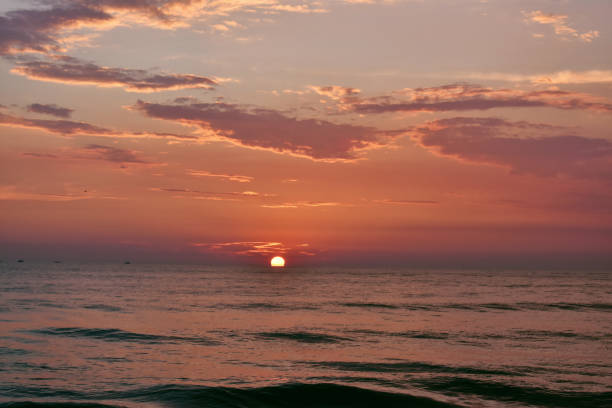 istock sun setting just in middle of a ocean in Goa 1207726794