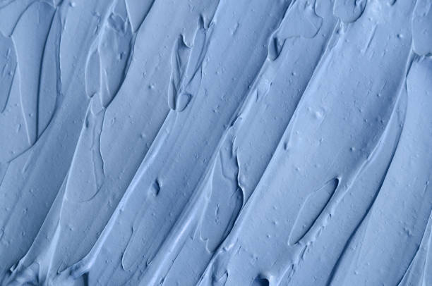 istock Light blue facial clay (mask, face cream, body wrap) texture close up, selective focus. Abstract background with brush strokes. 1207727468