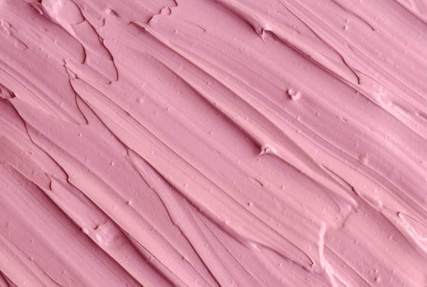 istock Pale pink cosmetic clay (rhassoul, facial mask, face cream, body wrap) texture close up, selective focus. Abstract background with brush strokes. 1207727540