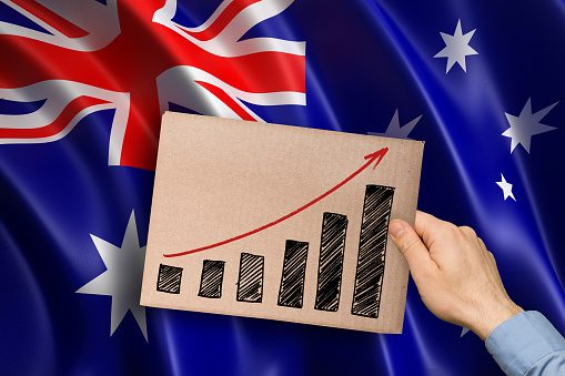 hand showing growing bar graph over Australian flag