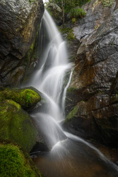 istock Water Stream collapses among Huge Mossy Granite Rocks 1207730612