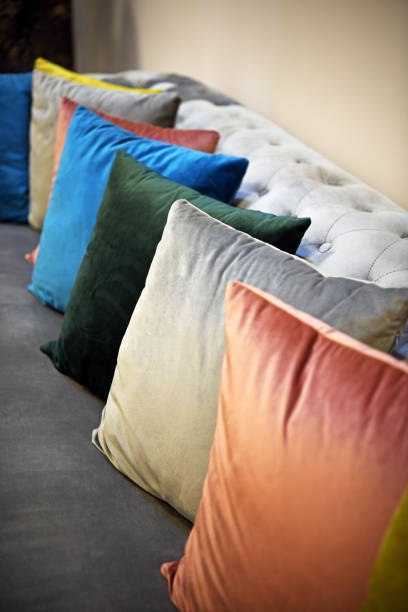 istock Beautiful little pillows stacked side by side. Pillows in different colors on the sofa. 1207731183