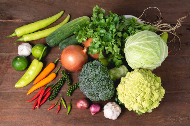 istock Various kinds of fresh vegetable on rustic wood background with copy space for text, garlic, cucumber, carrot, broccoli, cabbage, healthy organic veggie concept 1207732460