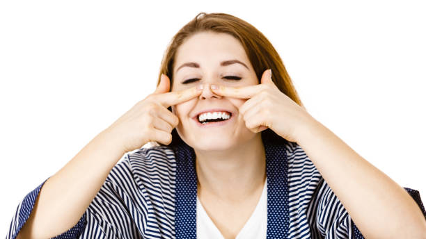istock Happy cheerful woman touching her nose 1207735350