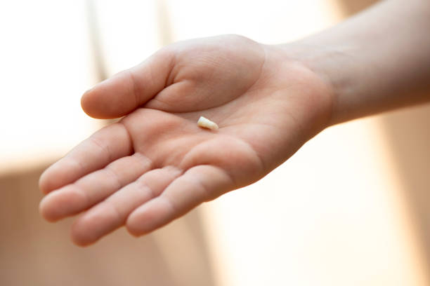 istock Child Showing His First Lost Milk Tooth 1207735669