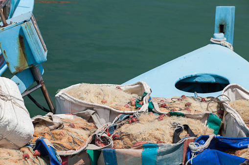 Fishing nets lay on a boat moored in Ayia Napa port, Cyprus