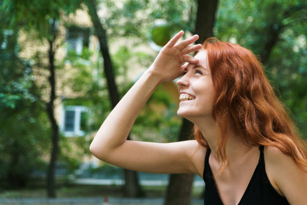 istock Beautiful ginger girl in park. 1207739670