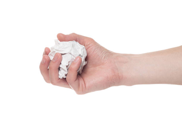 istock Hand holding crumpled paper isolated on white background 1207743475