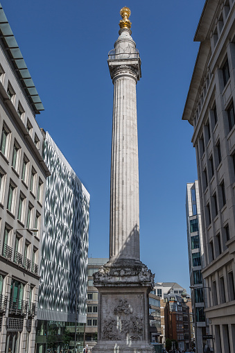 Modern-day View of the Monument to the Great Fire of London fluted Doric column built of Portland stone topped with a gilded urn of fire.