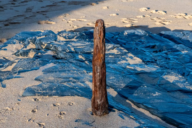 A rusty metal mooring post on the Cornish coast