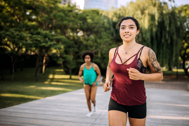 istock Two girlfriends on morning exercise at the park 1207749577
