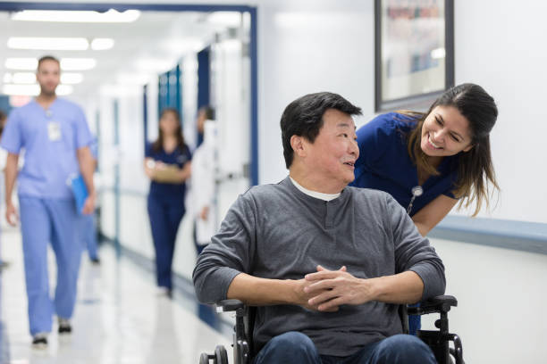 istock Caring nurse talks with senior man 1207751573