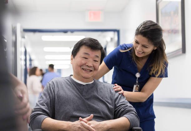 istock Smiling senior man talks with nurse 1207751766