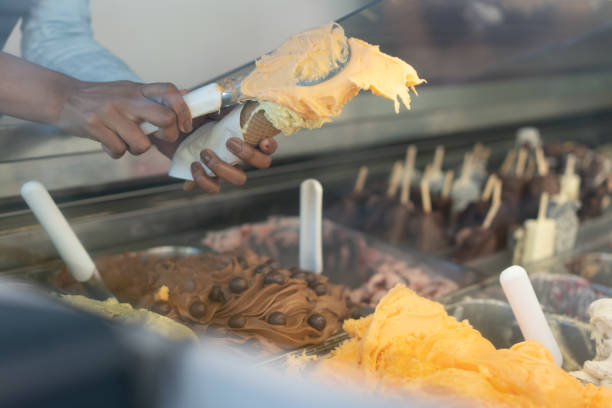 istock Latin saleswoman preparing an ice cream cone 1207753089
